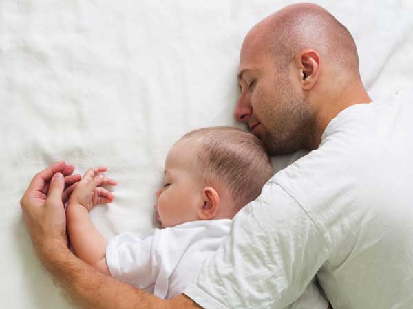 Father and baby sleeping