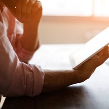 Male patient reading from tablet